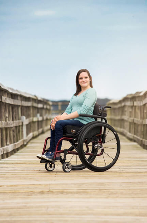 Young lady sitting in a wheelchair outdoors
